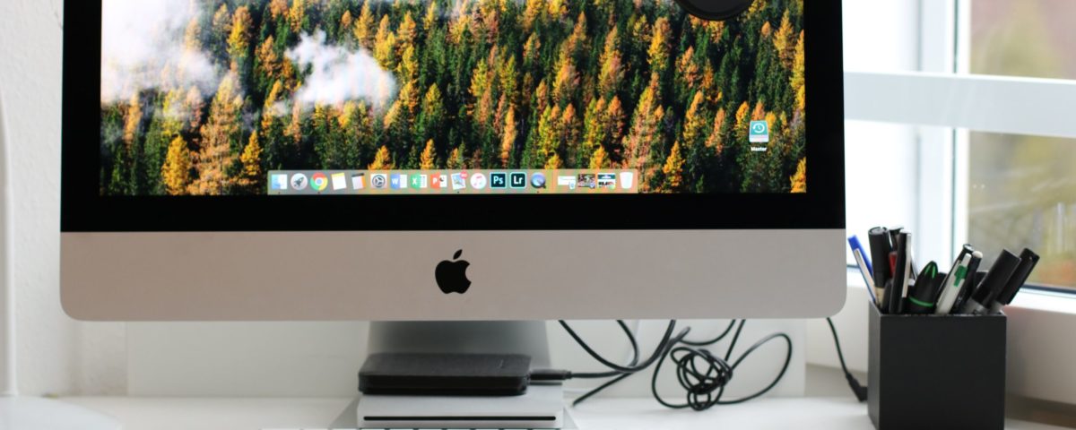 Free Turned on Silver Imac With Might Mouse and Keyboard Stock Photo